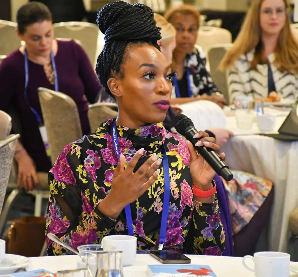 A participant holding the mic at WiCS breakfast event.