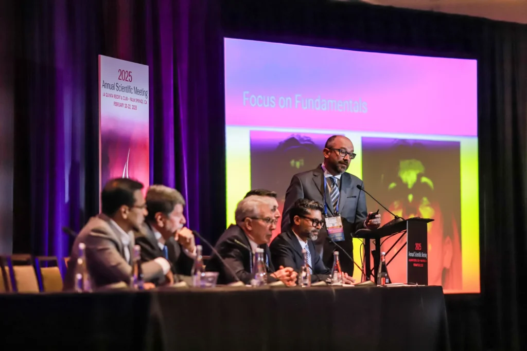 Presenters are on the stage at the annual scientific meeting.