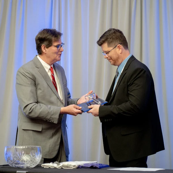 Mandell-Lowery Dr. Mark Mandell-Brown is presenting an award to Dr. Chris Lowery.