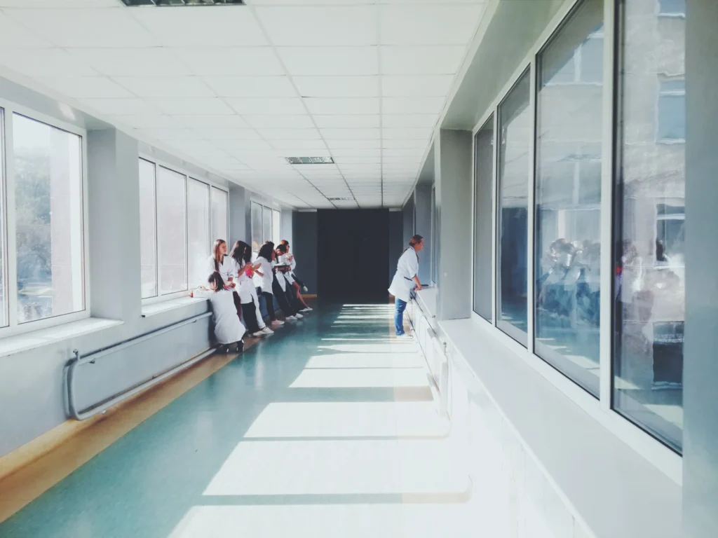 People standing in a hallway in white shirts.